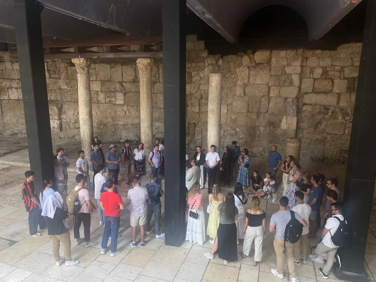 Itzik guiding a group among Jerusalem's historic stone arches
